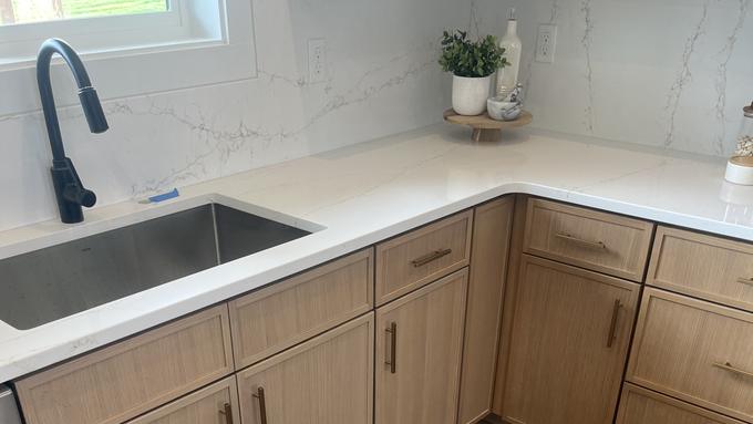 Solid surface countertop with undermount sink on white oak base cabinets
